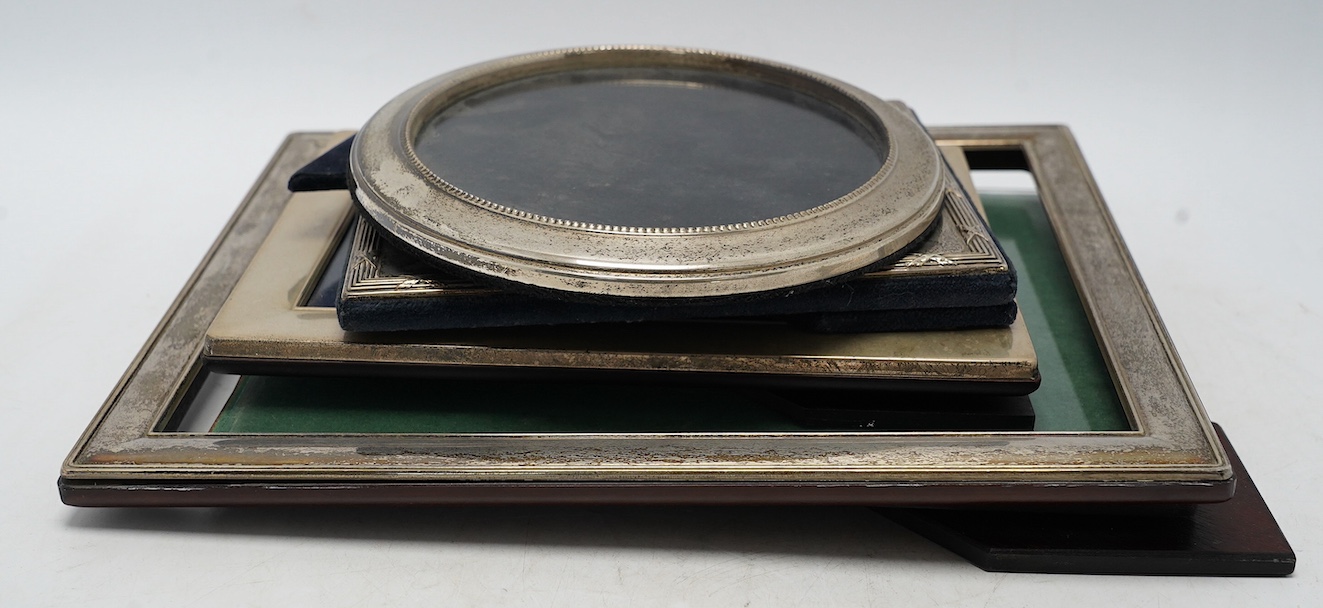 Four assorted modern silver mounted photograph frames, largest 29.2cm. Condition - fair